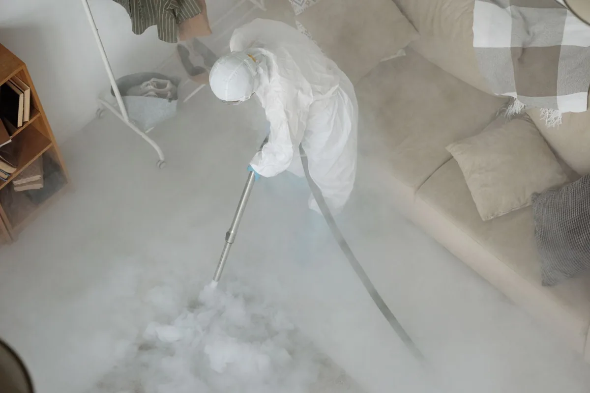 Biohazard cleanup technician in protective equipment, Fowlerville, MI